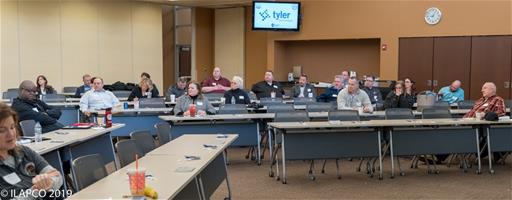 People look toward person speaking at Symposium.